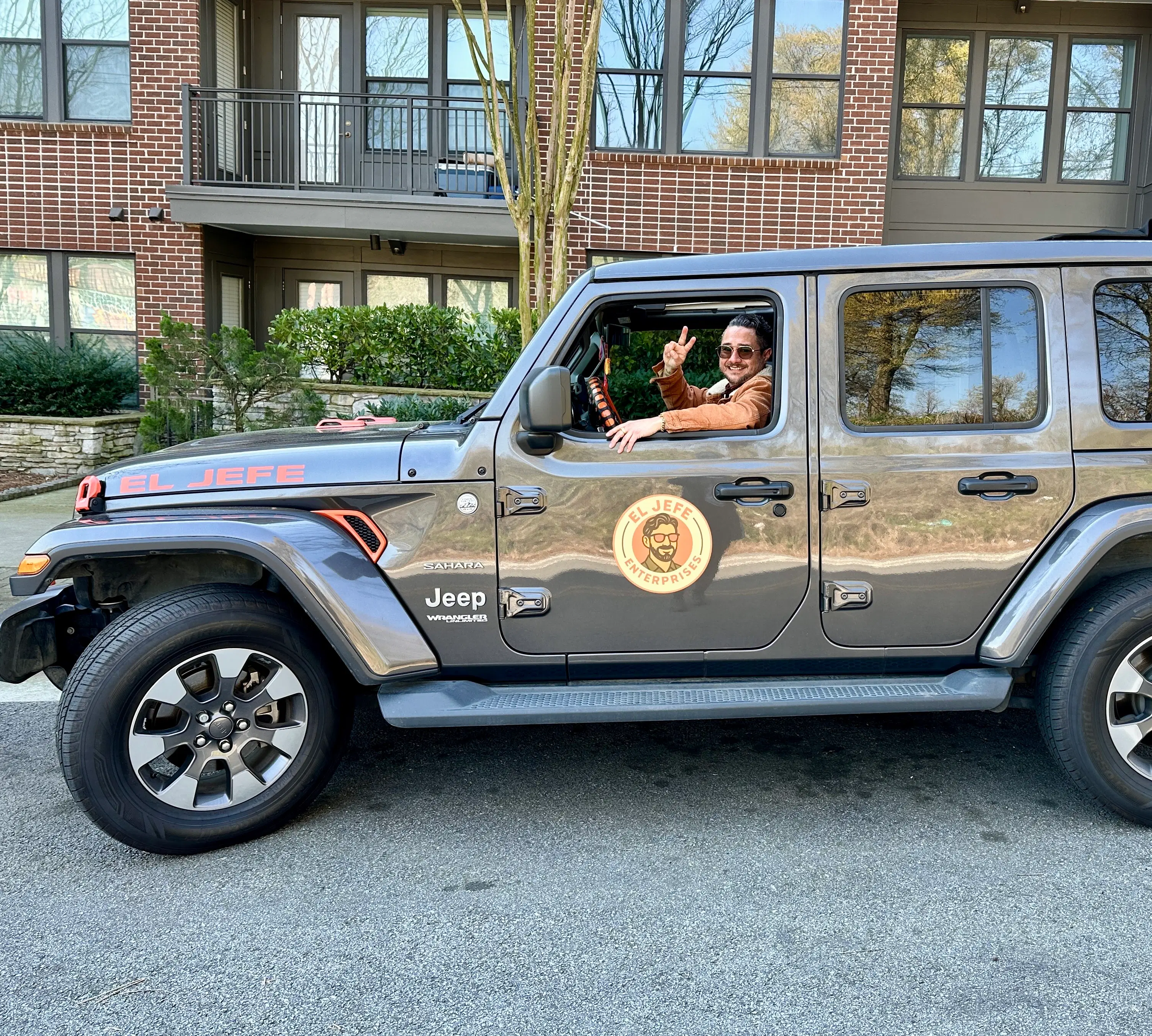 The founder of El Jefe Enterprises driving a Jeep Wrangler, representing a hands-on, approachable, and community-focused consulting style.
