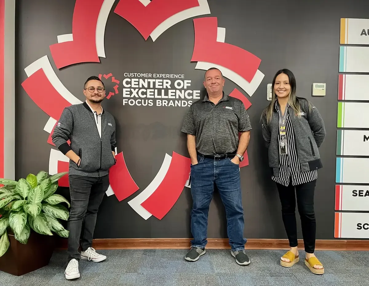 Johnny Tellez with colleagues at a franchise operations center